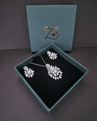 Jewelry set with necklace and earrings in a box with a brand logo.