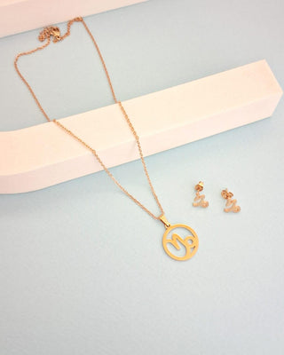Gold necklace and earrings on a light blue background