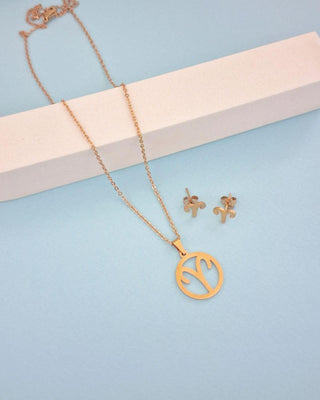 Gold necklace and earrings on a light blue background