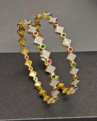 Gold necklace with diamond and gemstone accents on a gray background