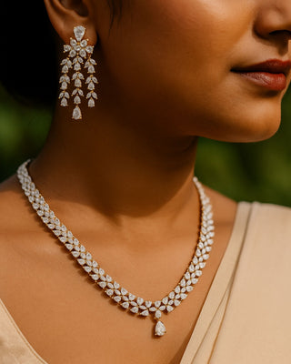 Close-up of a woman wearing a diamond necklace and earrings with a blurred background