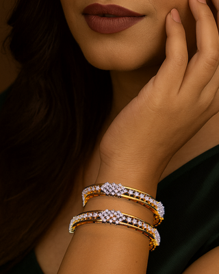Woman wearing gold bracelets on a dark background